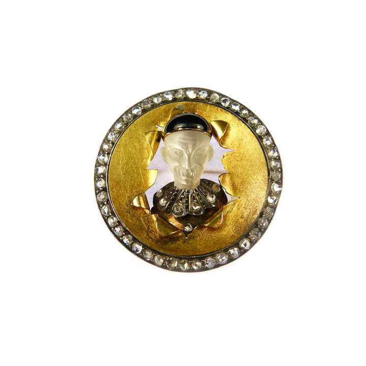 Moonstone, diamond and enamel gold circle brooch, depicting a caricature Chinese man bursting through a drumskin